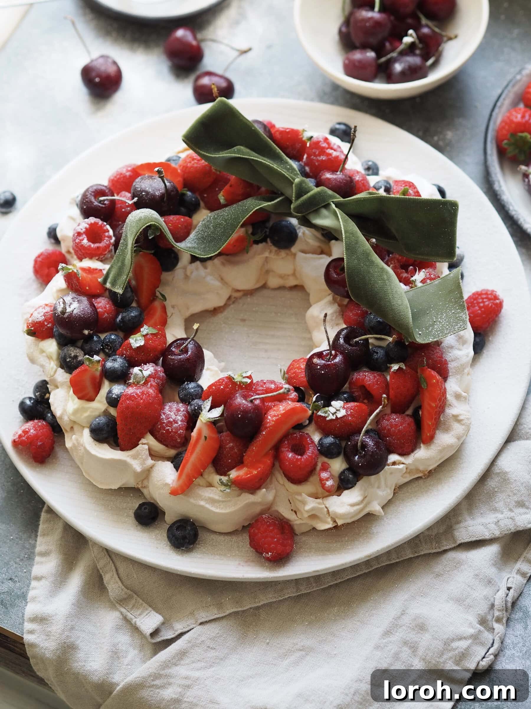 Festive Meringue Wreath 15 Topping the pavlova with berries and a ribbon