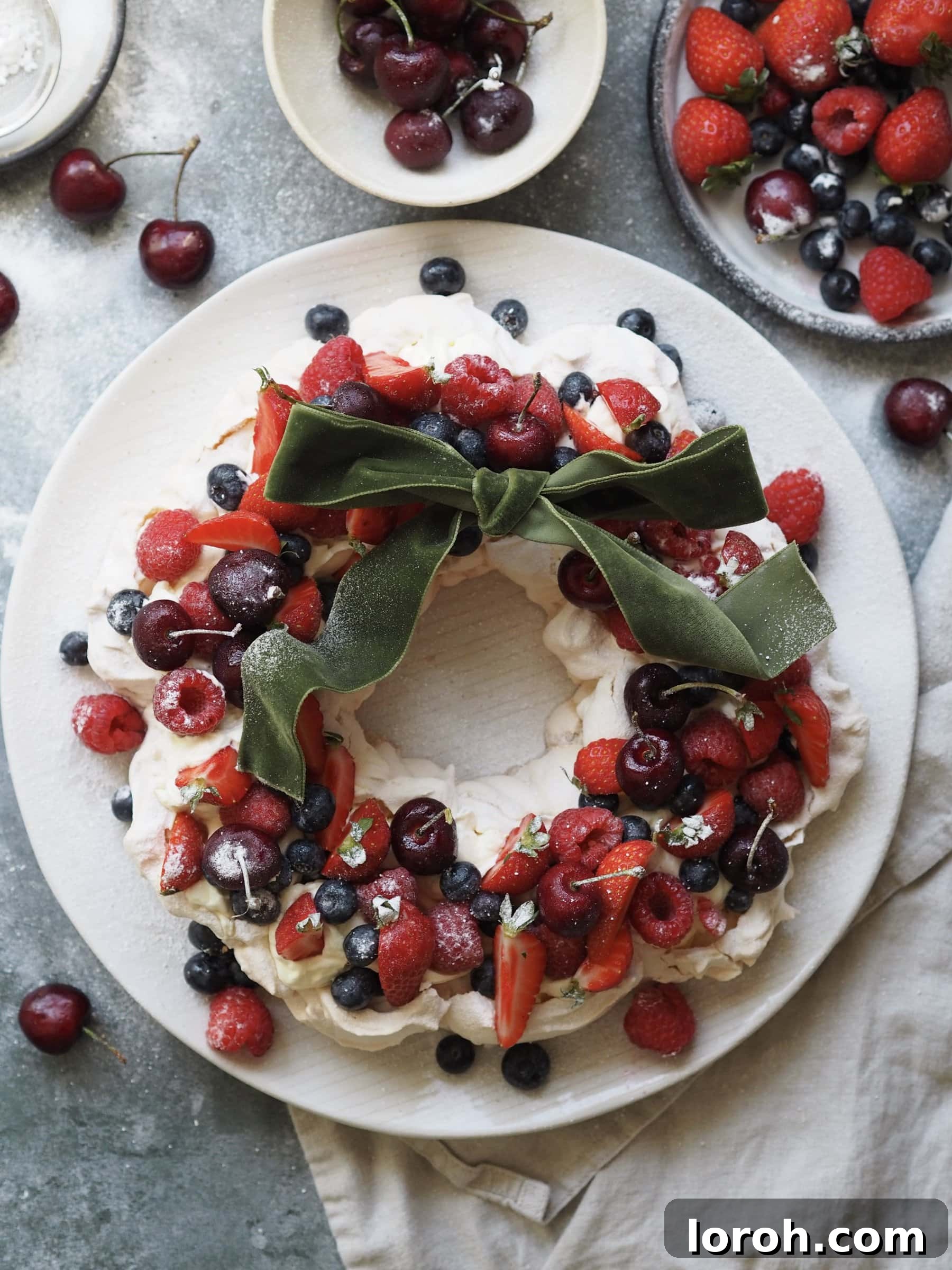 Festive Meringue Wreath 3 Christmas Pavlova on a plate with berries and cherries