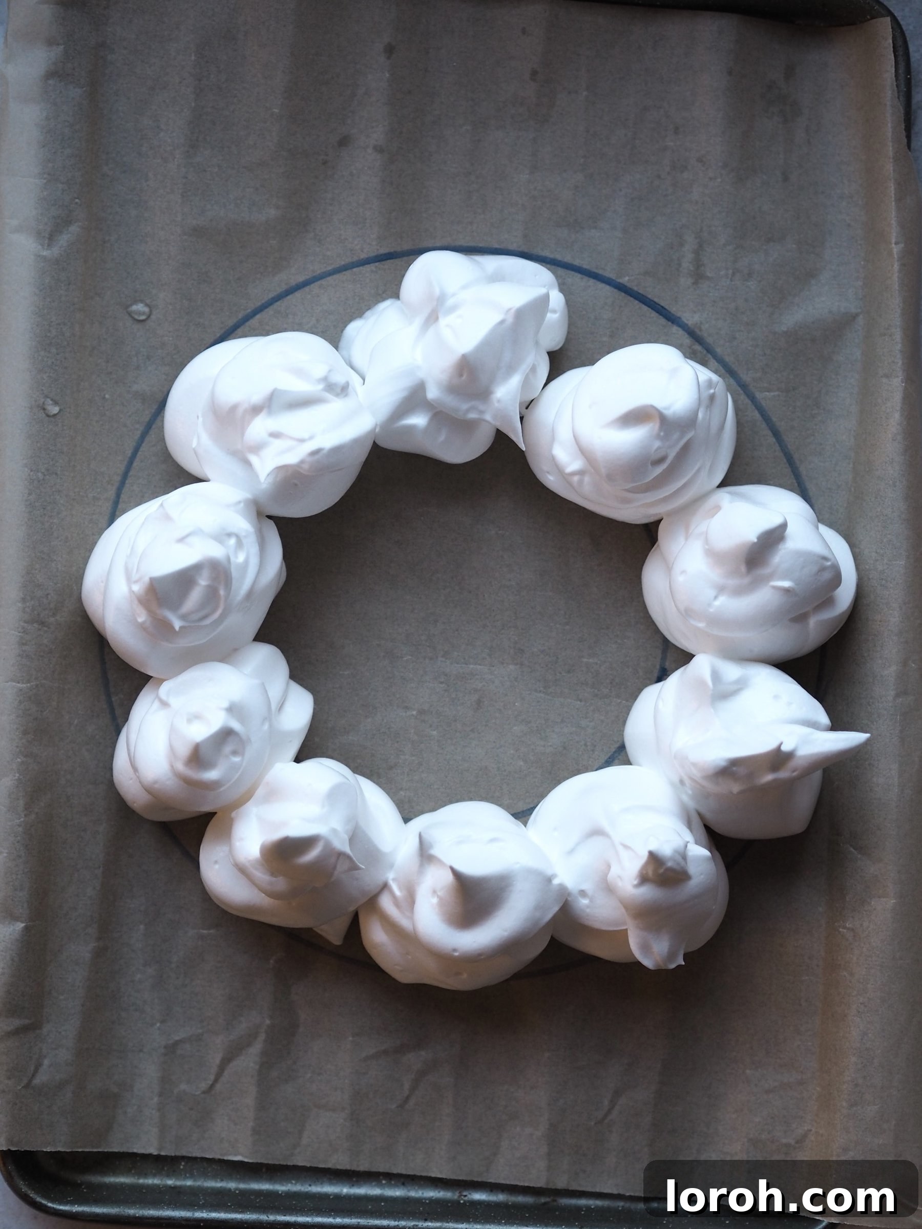 Festive Meringue Wreath 10 Piping the meringue into circles inside the circle to make a wreath shape.