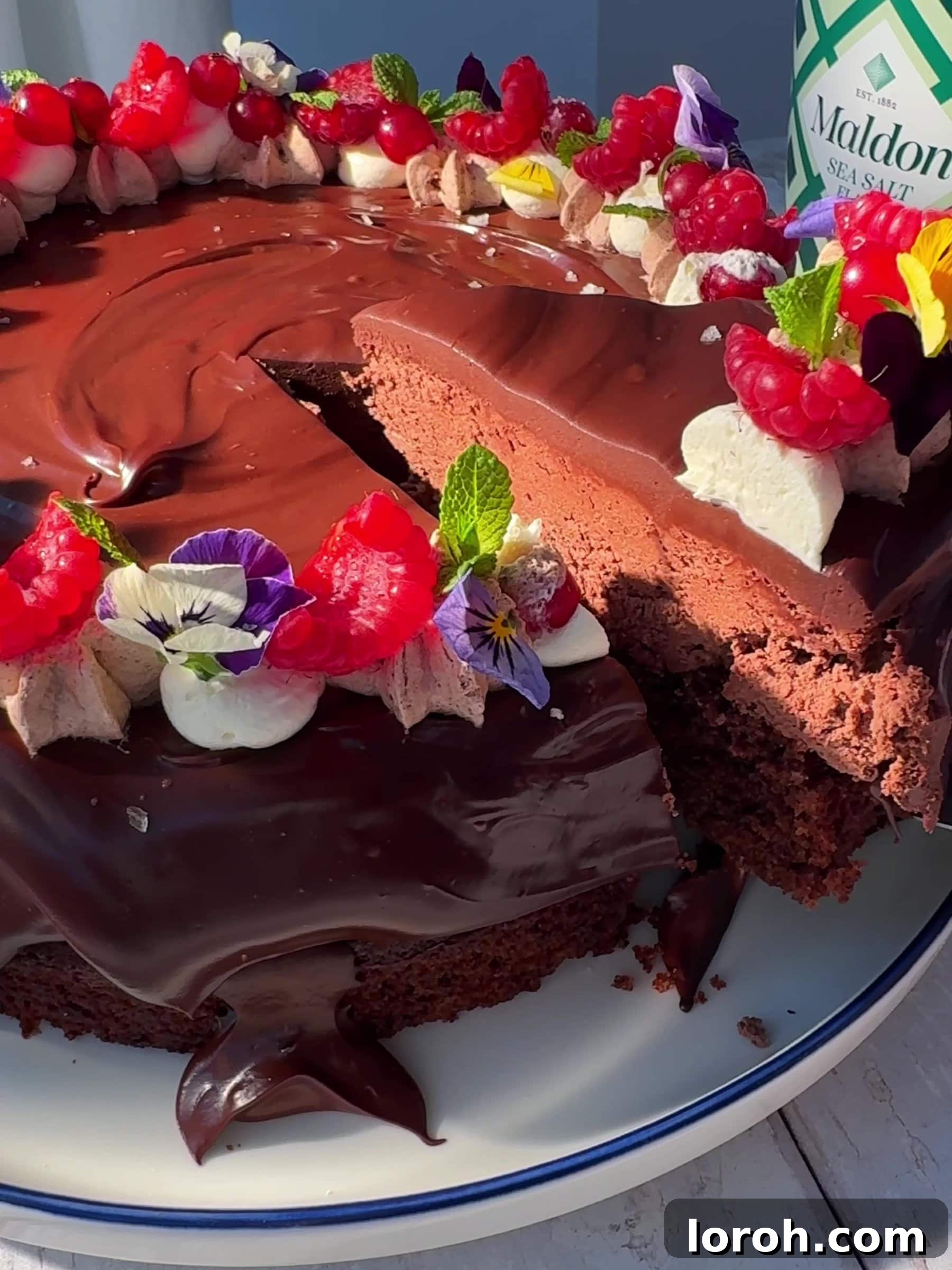 Slicing a piece of the Chocolate Cake with a knife, revealing the luscious layers of cake and mousse.