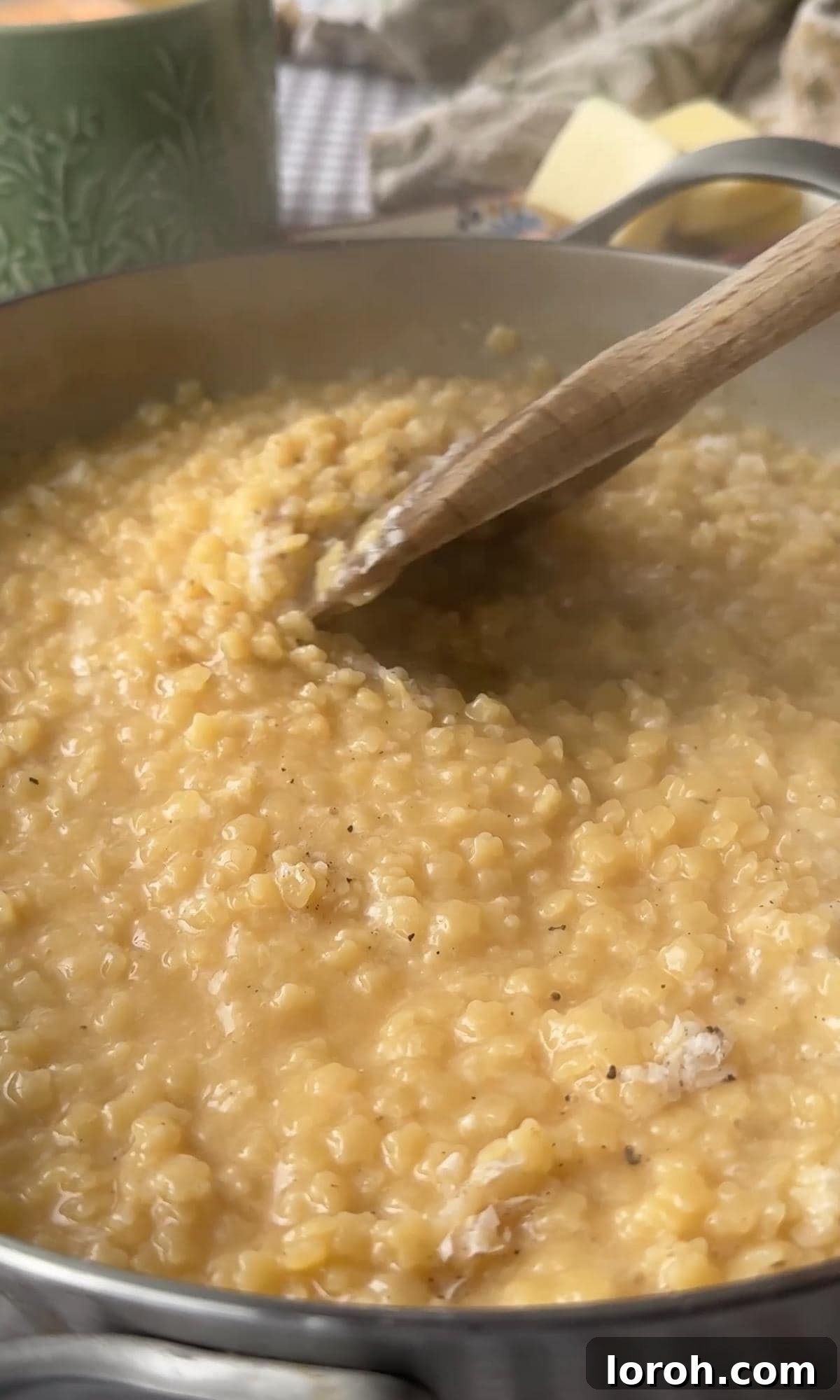 Velvety Easy Pastina 7 Stirring the creamy pastina to combine all ingredients before serving.
