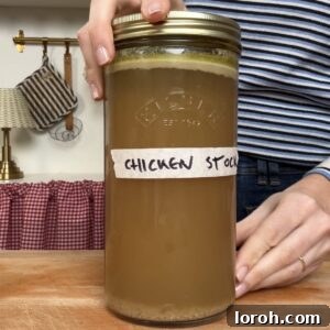 Homemade chicken stock in a jar, ready for storage.