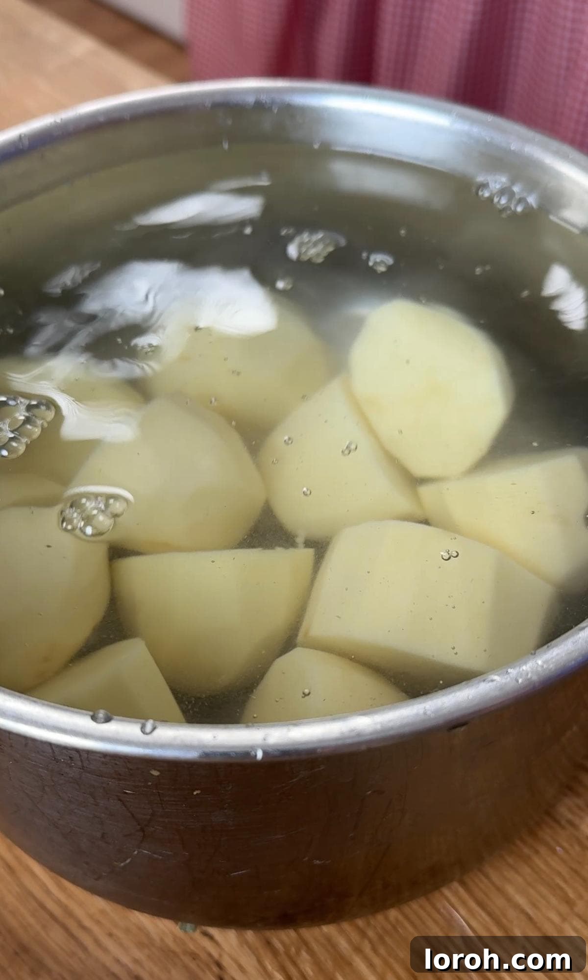 parboiling the white potatoes in a large saucepan with salted water.