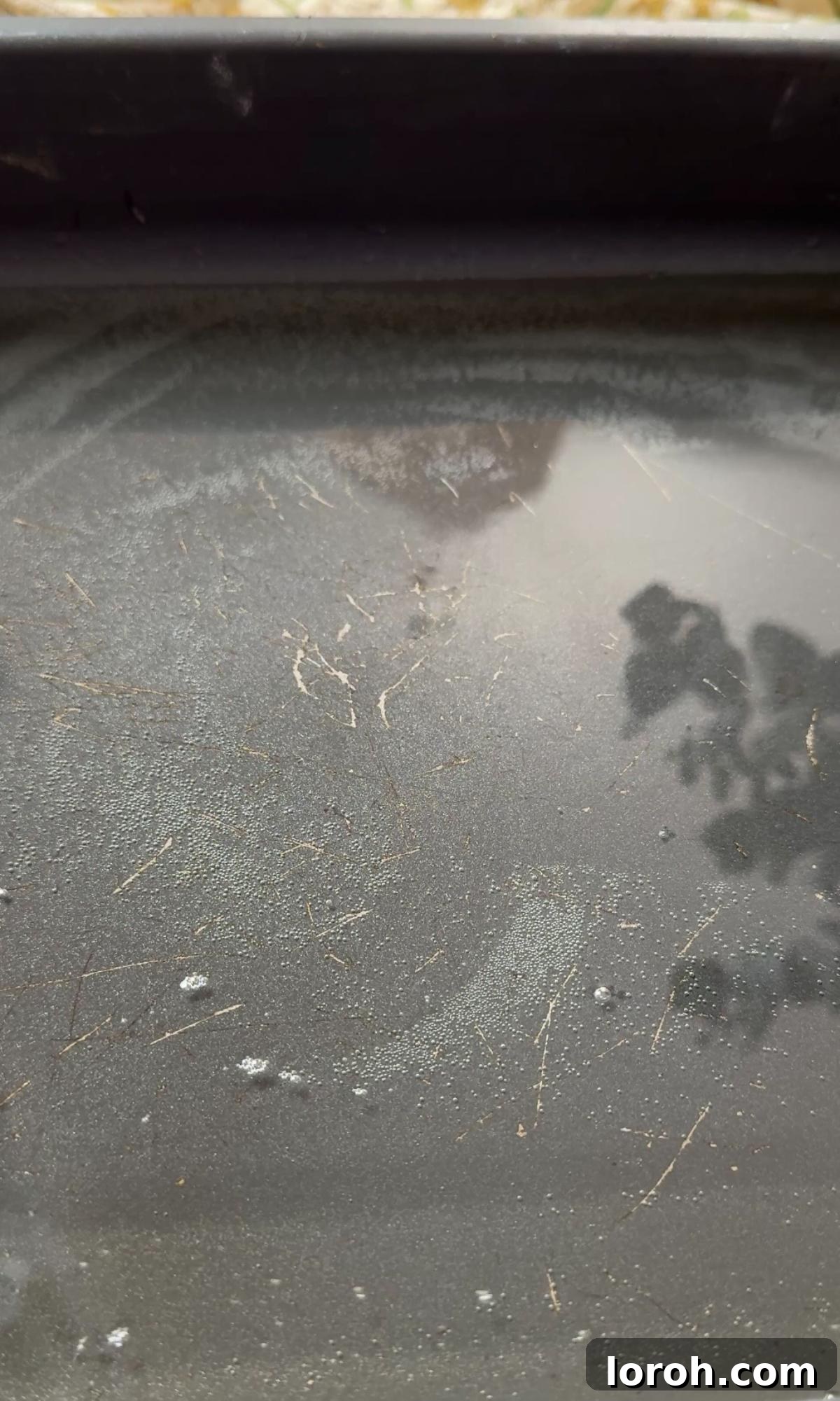 hot oil shimmering in a large baking tray, preheating in the oven.