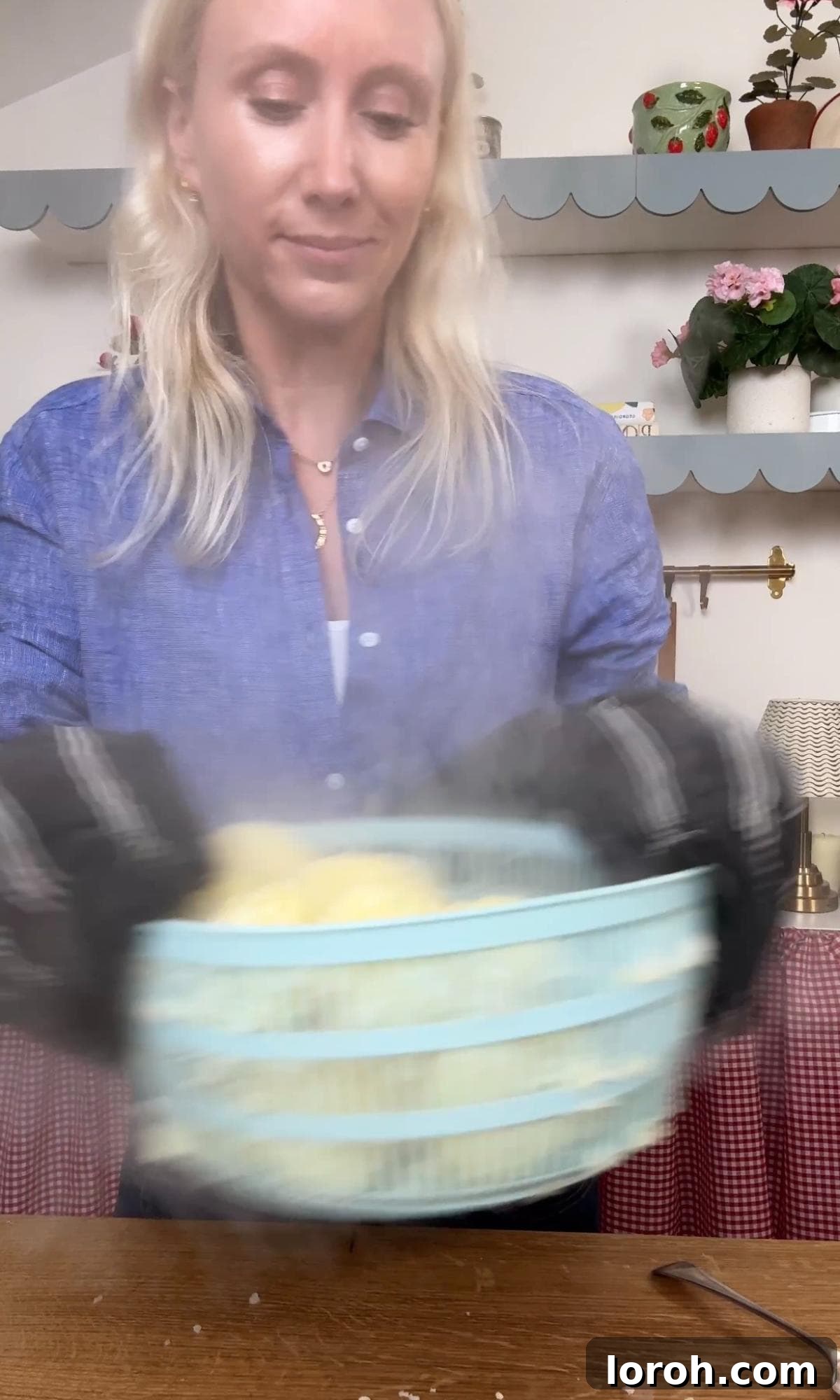 shaking a colander of parboiled potatoes to rough up their edges.