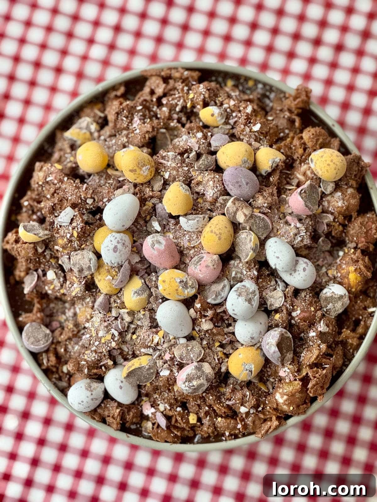 An inviting overhead shot of the finished Cornflake Dream Cake with Mini Eggs, showcasing its layered textures and festive topping.