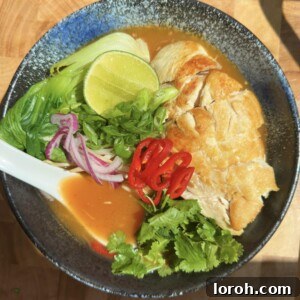 wagamama chilli chicken ramen in a blue bowl with a ramen spoon
