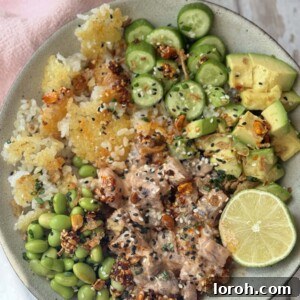 spicy tuna in a bowl with crispy rice and cucumber and avocado