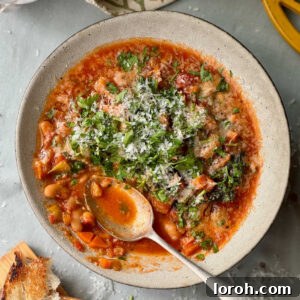 bean stew in a bowl with bread on the side.
