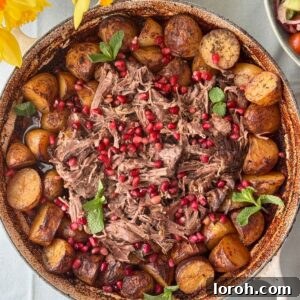 slow cooked lamb with potatoes in a tray.