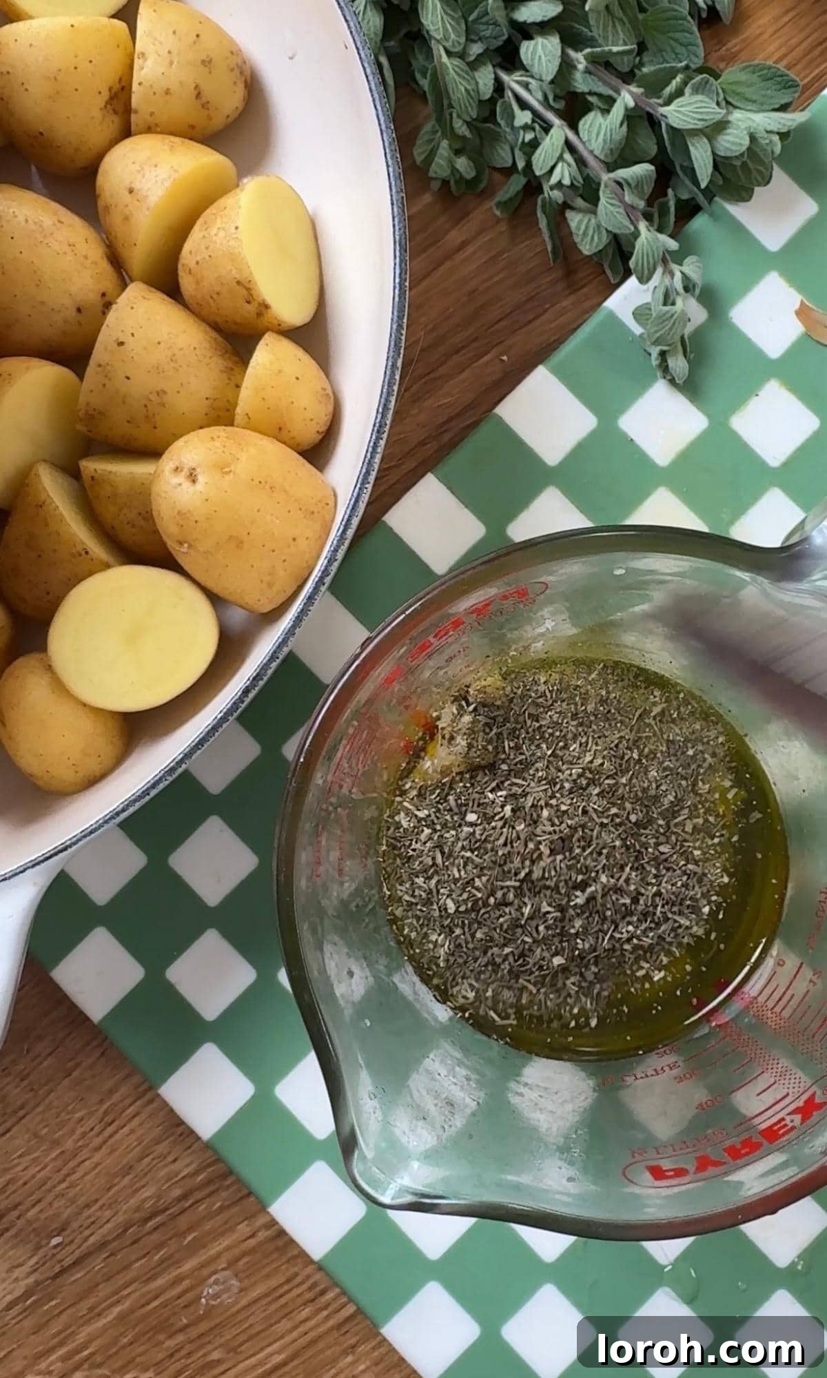 Mixing extra virgin olive oil, minced garlic, preserved lemon, oregano, dijon mustard, salt, and pepper in a measuring jug to create the marinade.