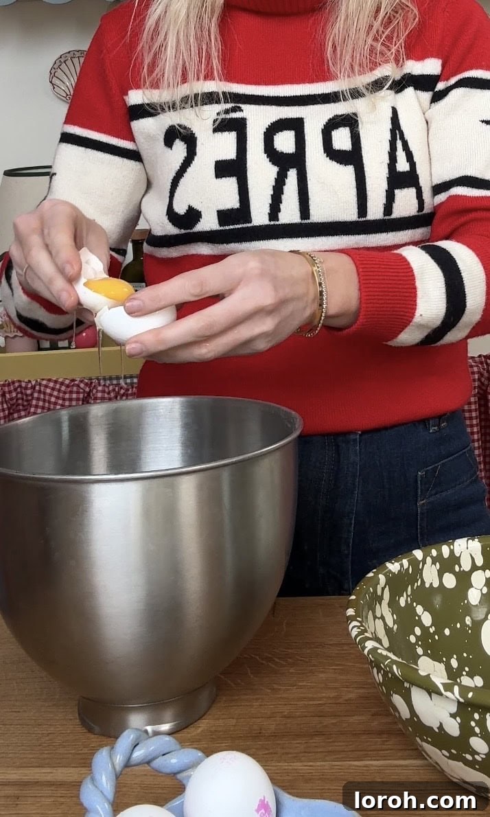Carefully separating egg yolks and whites into two different bowls.